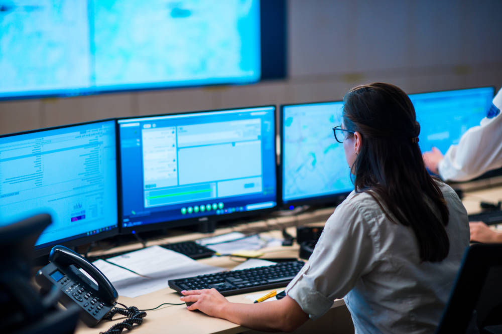 Amtivo (Formerly Certification Europe and EQA) - Alarm Monitoring. A worker in an alarm receiving centre, on their computer