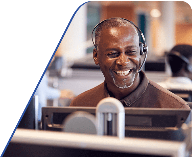 Amtivo (Formerly Certification Europe and EQA) ISO 27001 - Information Security. A worker at their desk on a call.