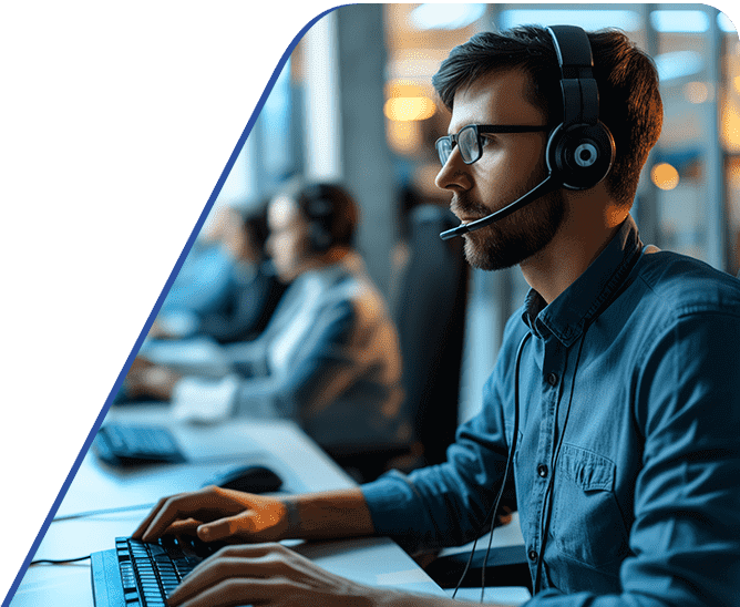 Amtivo (Formerly Certification Europe and EQA) - ISO 27701 Privacy Information Management Systems. A row of workers at their desks with a focus on one with a headset on.