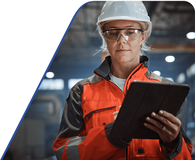 Amtivo (Formerly Certification Europe and EQA) - ISO Standard Certification Transfer - Worker in a hardhat and protective eyewear working on a tablet.