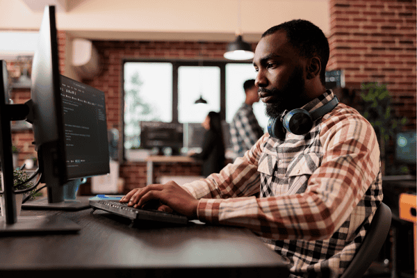 Developer working on AI system in a modern office setting