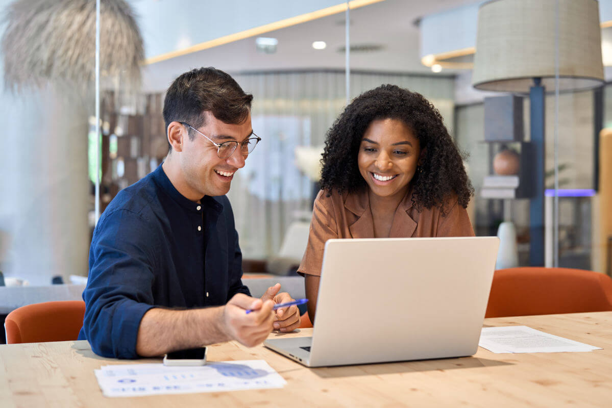 two humans sat at a desk discussing agents and brokers certification