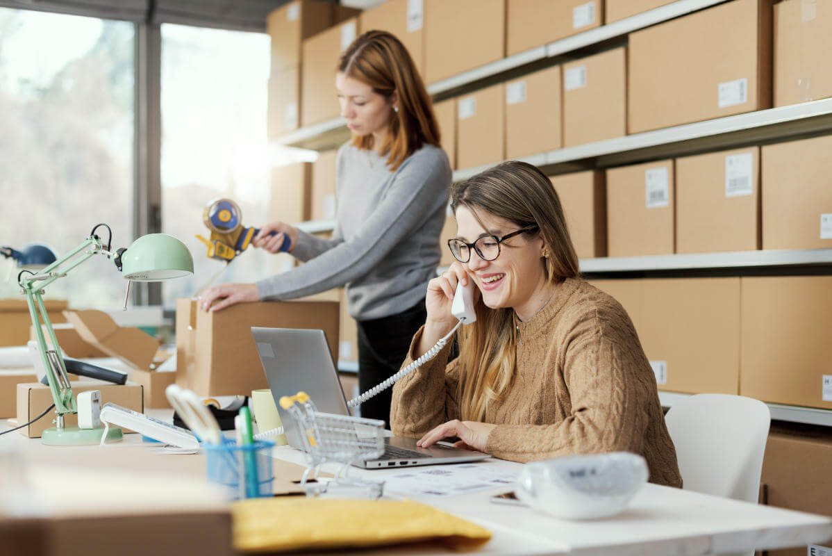 woman sat at a desk, discussing packaging