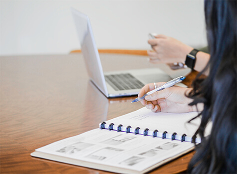 How to ISO 9001 certification – woman writing in notebook