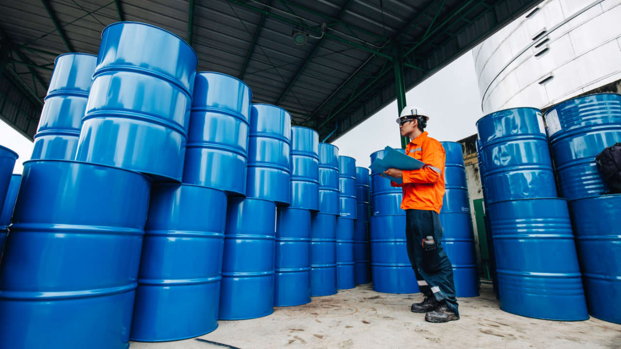 ISO 14001 certification - worker inspecting waste storage